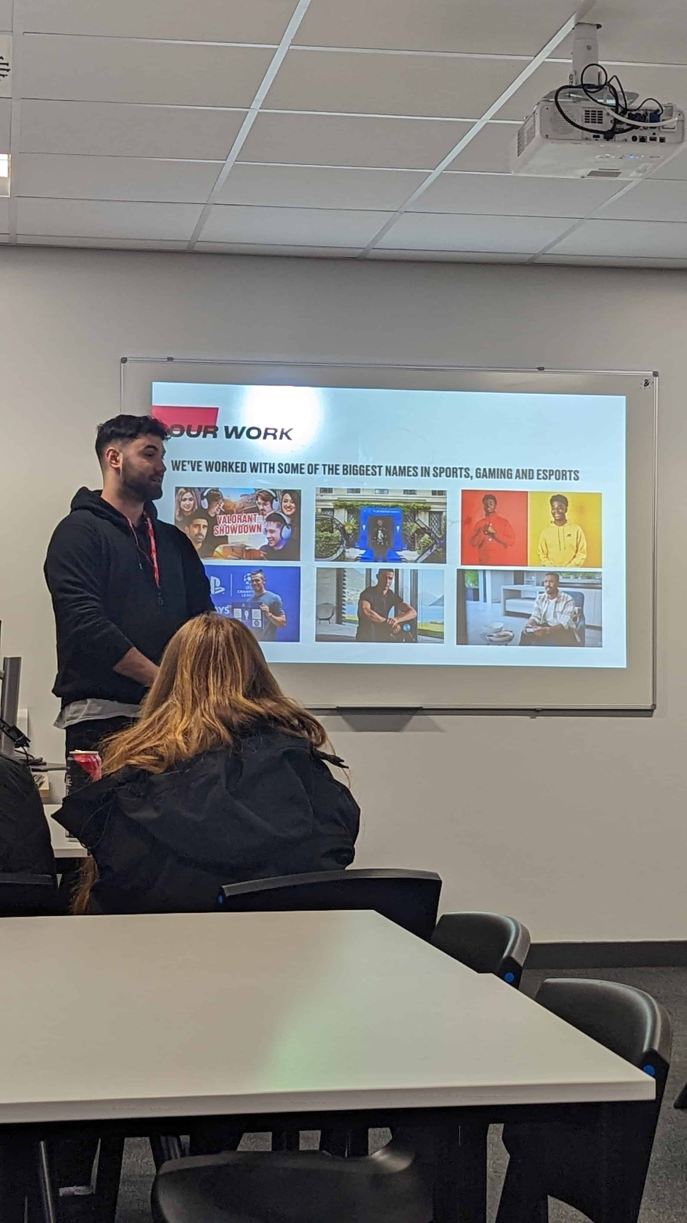 Cam, an Account Manager from Ear to the Ground, speaks in a classroom at Hazel Grove Sixth Form to students about the work he does with the company.