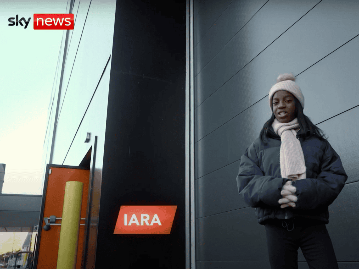 Hazel Grove High School student Iara stands in front of the Energy House Laboratories as she presents a news report for Sky News Kids, FYI weekly news show.